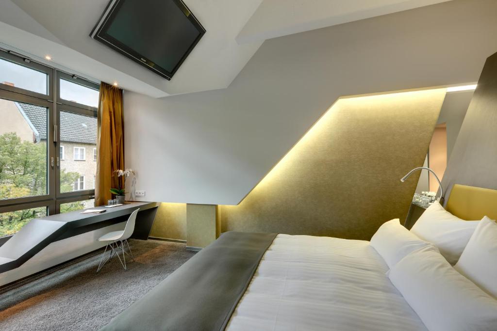 Postel nebo postele na pokoji v ubytování Aspria Berlin Ku'damm Sport & Spa