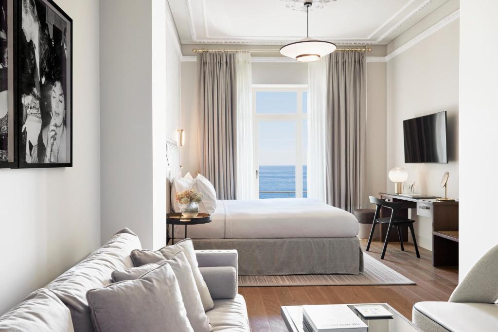 a living room with a bed and a room with a bed at ON Residence - Small Luxury Hotels of the World in Thessaloniki
