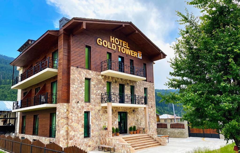 a building with a sign that reads hotel gold tower at Hotel Gold Tower in Mestia