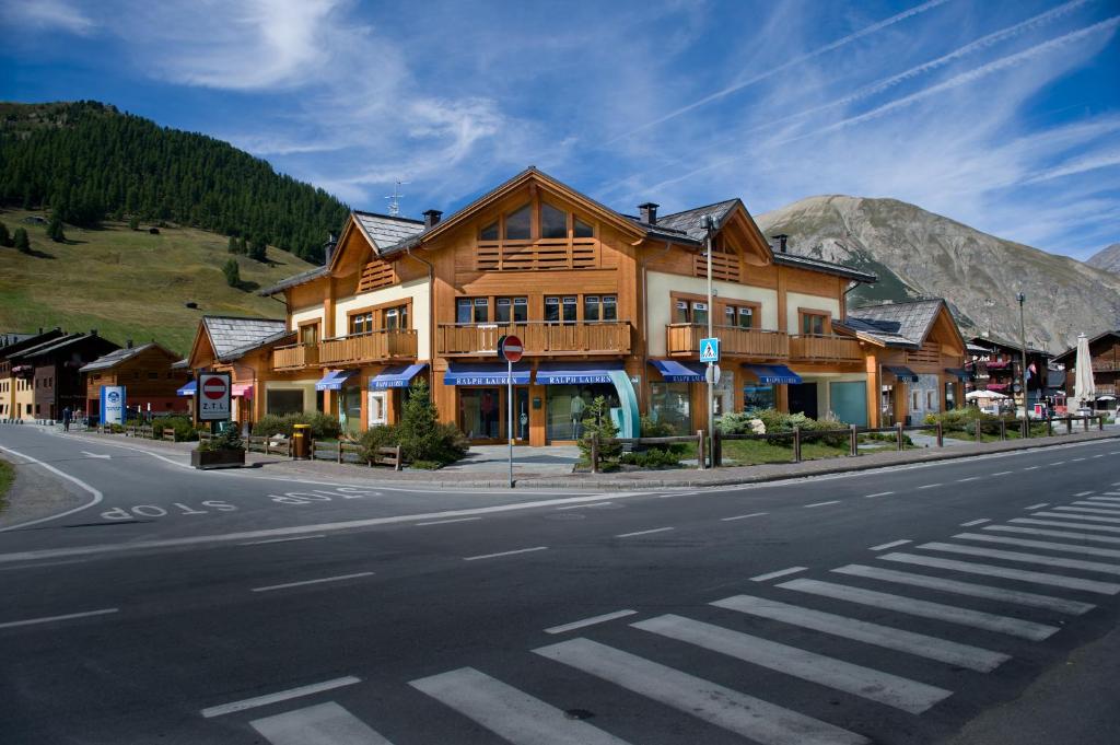 a large wooden building on the side of a street at Appartamento Isola in Livigno