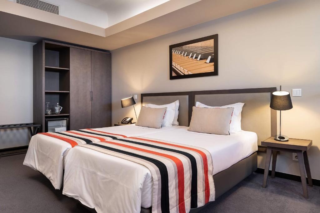 Cama ou camas em um quarto em Hotel do Chiado
