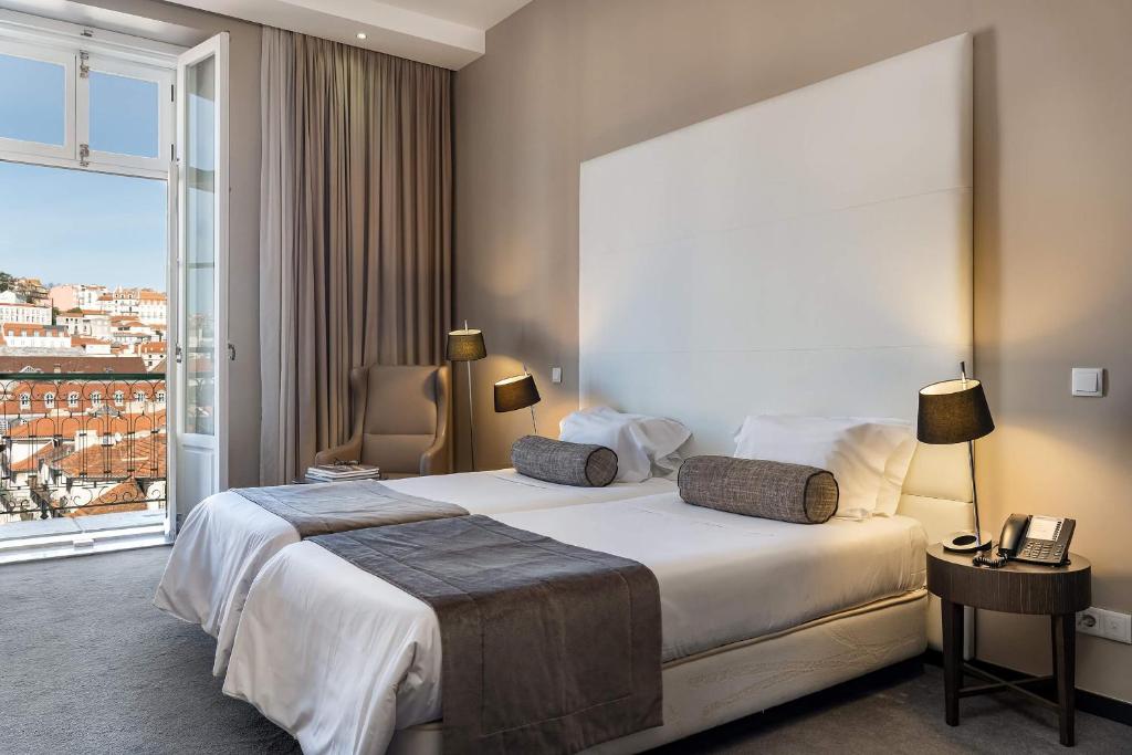 Cama ou camas em um quarto em Hotel do Chiado