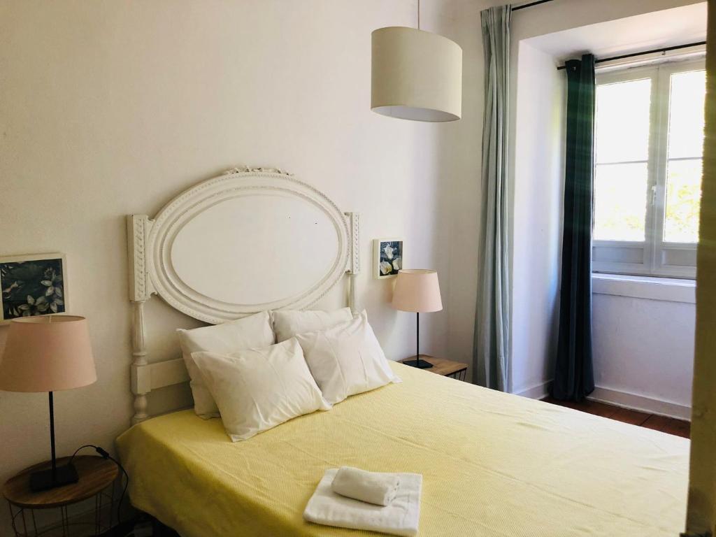 a bedroom with a bed with a mirror on it at Casa do Mocho II in Lisbon