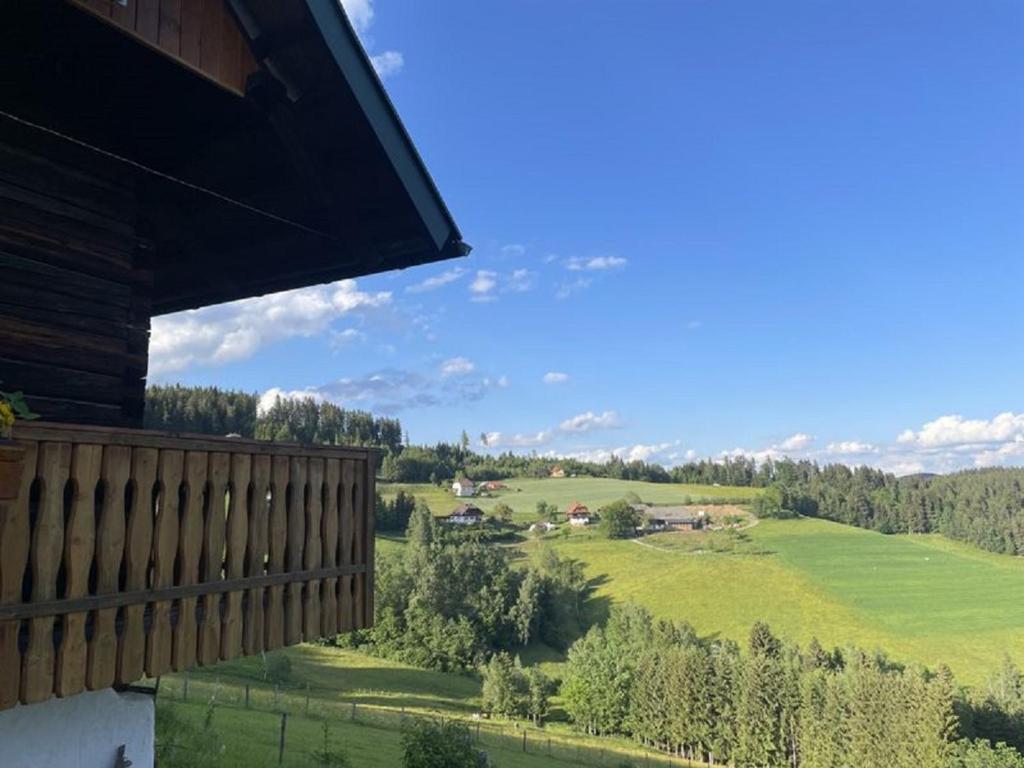 a balcony with a view of a green field at Andi's Berghütte in Weitensfeld