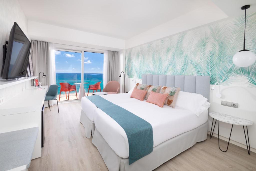 a hotel room with a bed and a tv at Hotel Cristina by Tigotan Las Palmas - Adults Only in Las Palmas de Gran Canaria