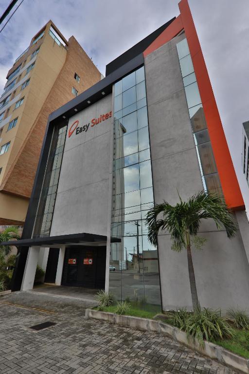 a building with a sign on the side of it at Easy Suites Natal in Natal