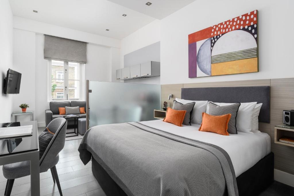 a hotel room with a bed and a desk at Templeton Place by Supercity Aparthotels in London