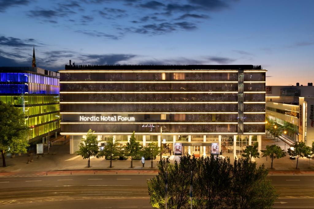 a building with a sign on the front of it at Nordic Hotel Forum in Tallinn