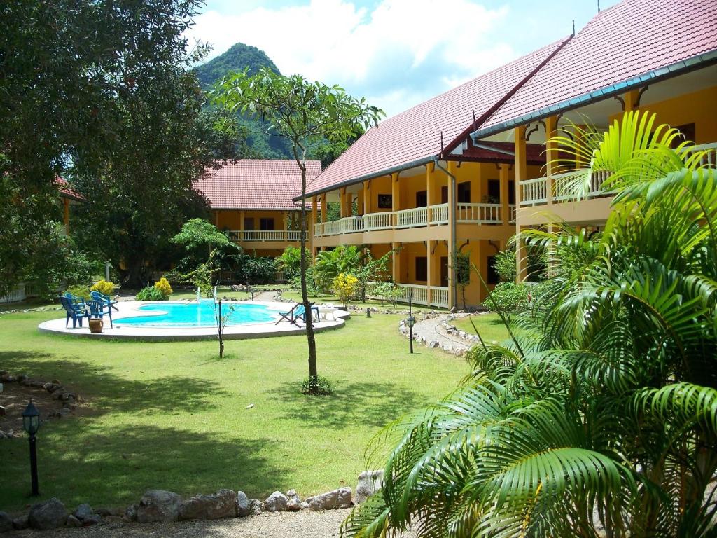 a resort with a swimming pool and a building at Sabai Residence in Ao Nang Beach