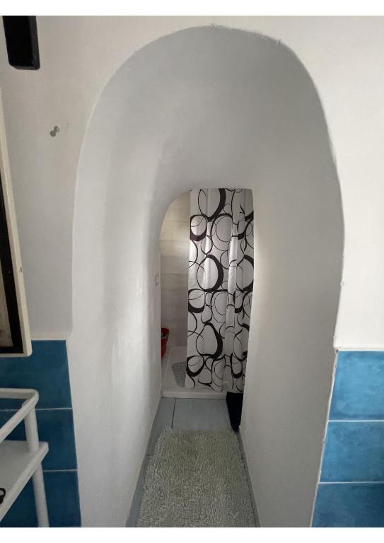 a hallway with an archway in a room with blue tiles at Amalfi Coast Casa Ida in Vietri sul Mare