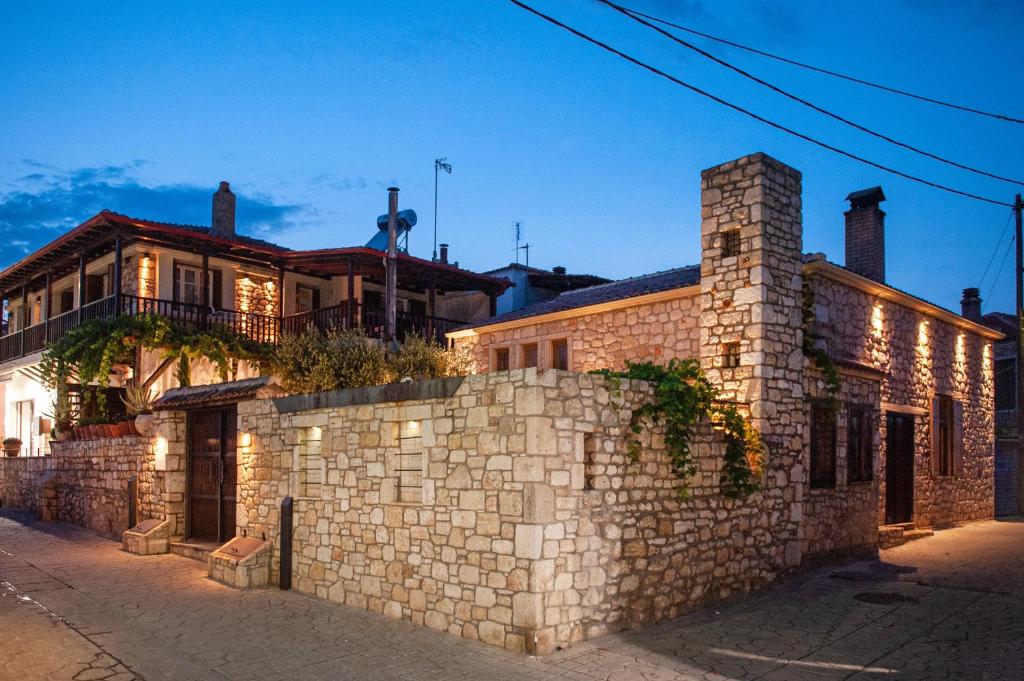 a stone wall in front of a house at Villa La Strada in Afitos