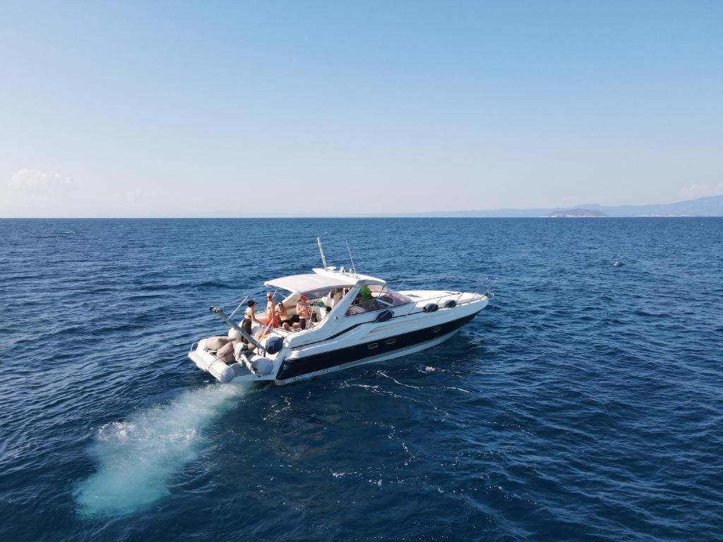 a group of people on a boat in the water at White Eagle Cruises Sani Beach in Sani Beach