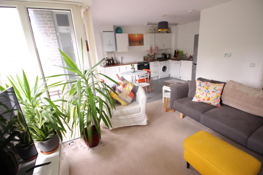 a living room with a couch and some plants at Spacious and airy 1 bedroom flat - Great location in London