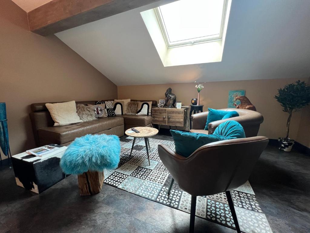 a living room with a couch and chairs and a skylight at Non in Montriond
