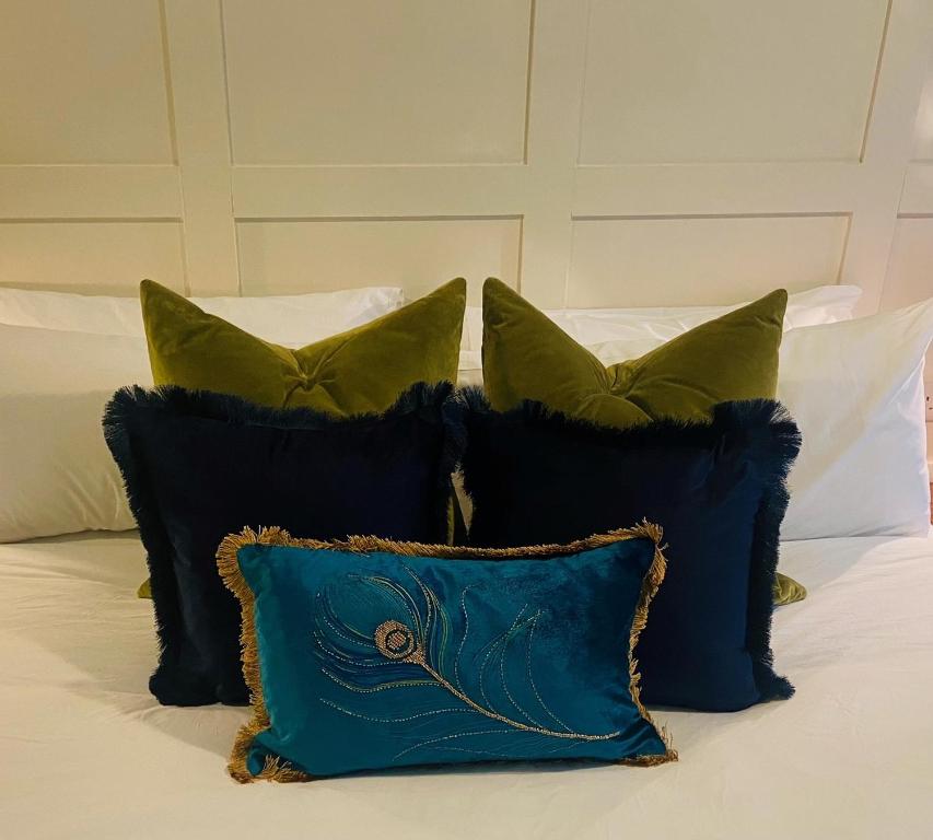 a group of pillows sitting on top of a bed at The Red Admiral Gosforth CA20 1BP in Seascale