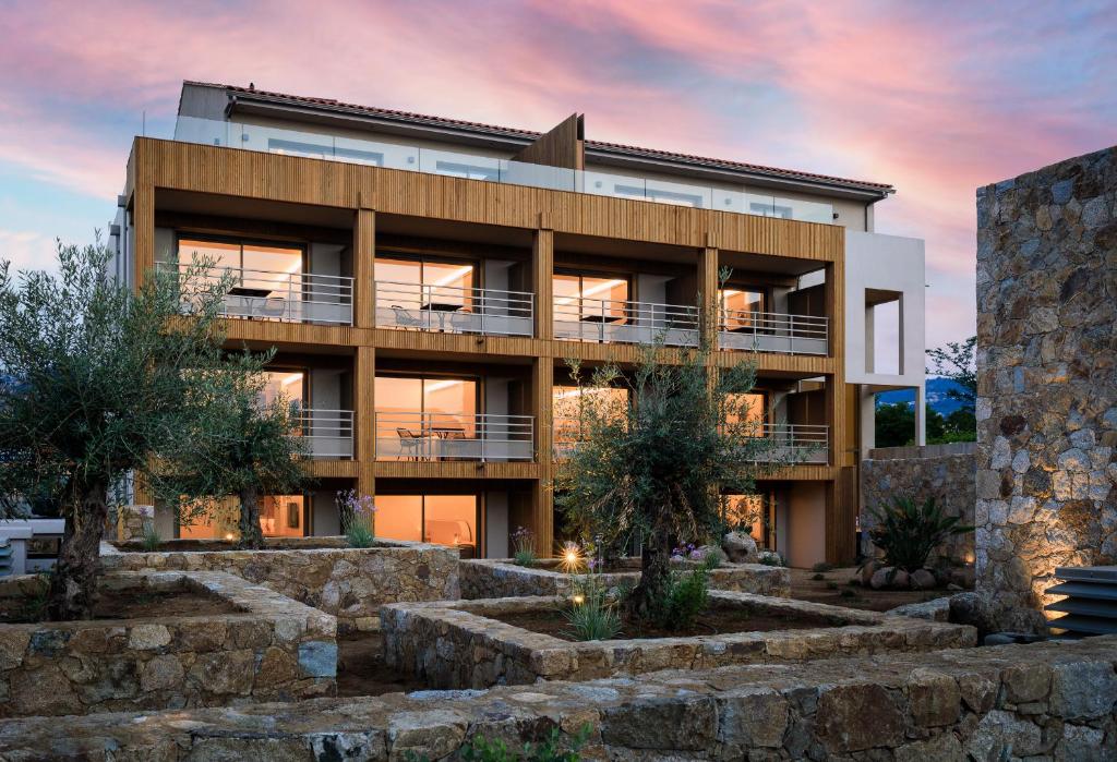 an exterior view of a building at sunset at RESIDENCE SANTA MARIA in LʼÎle-Rousse