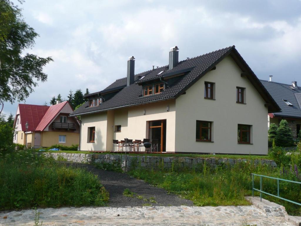 a white house with a black roof at Chata Marta in Boží Dar