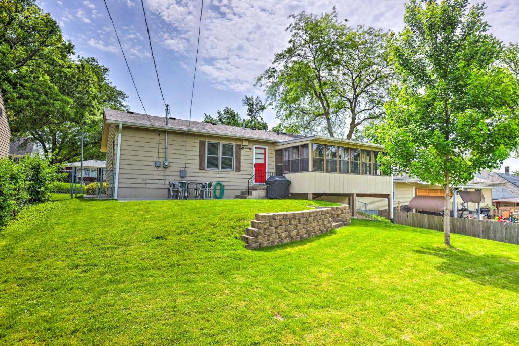 a house with a lawn in front of it at Family-Friendly Omaha Home about 5 Mi to Dtwn! in Omaha