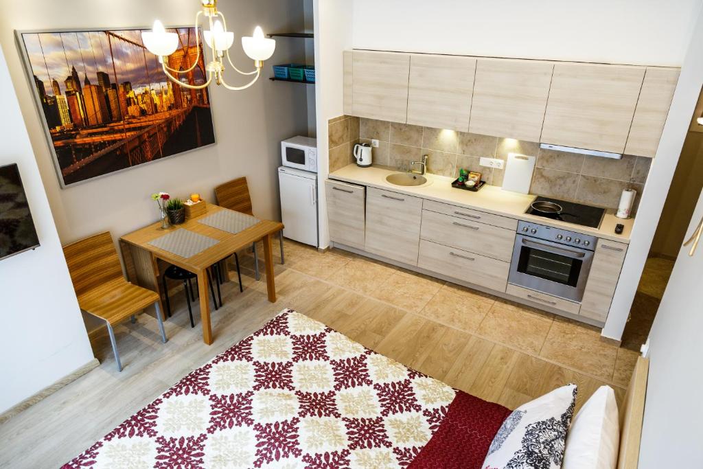 a kitchen with a table and a dining room at Hazel Apartment in Vilnius