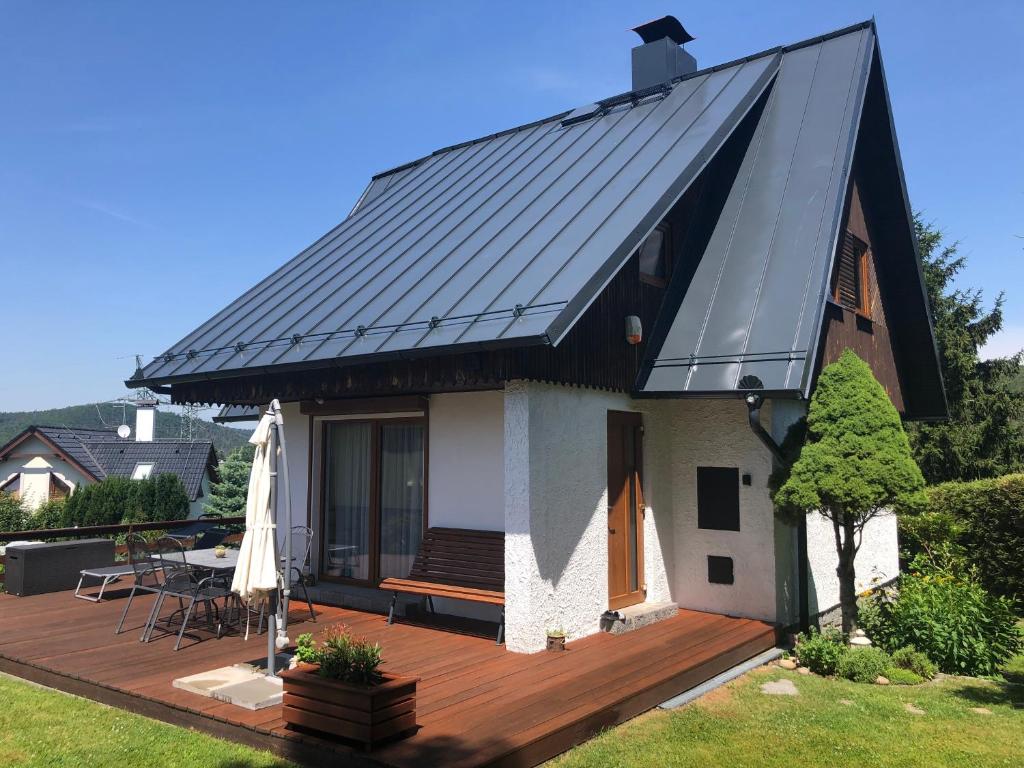 a house with a metal roof on a deck at Chata Trhovky 1 in Milešov