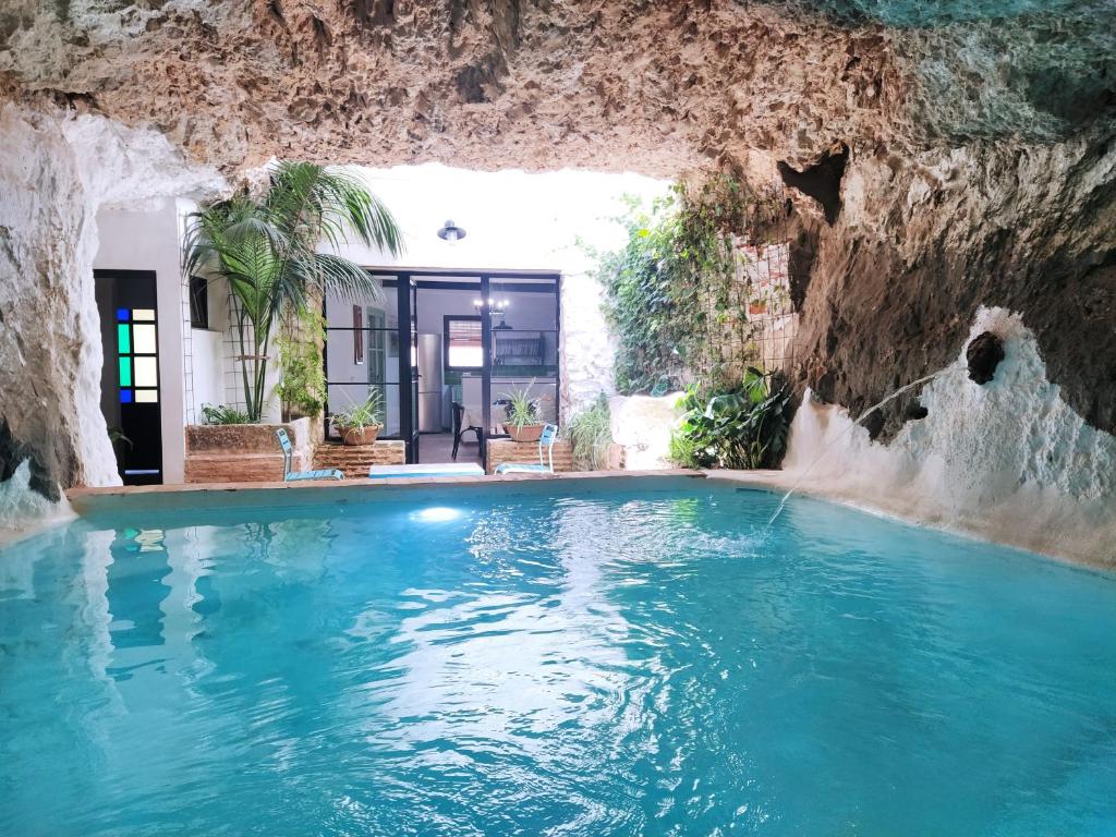 a swimming pool in a cave with blue water at la Alhábega in Villena
