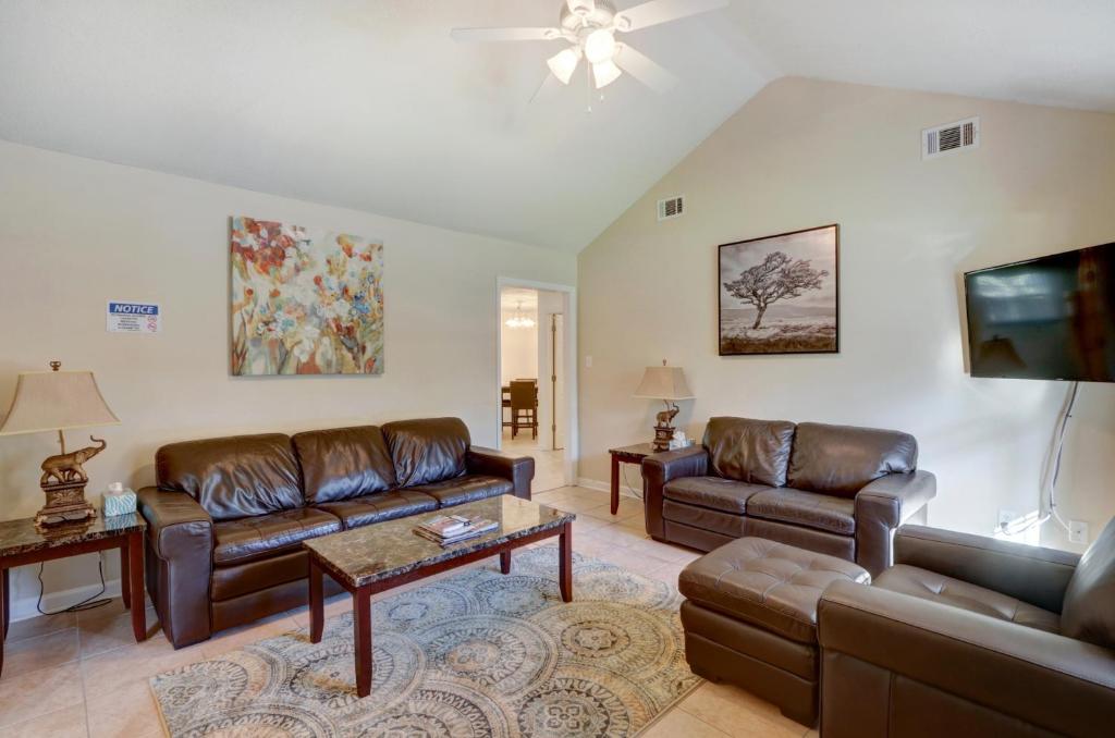 a living room with leather furniture and a flat screen tv at Pooler Travelers Retreat II - Entire House - in Savannah