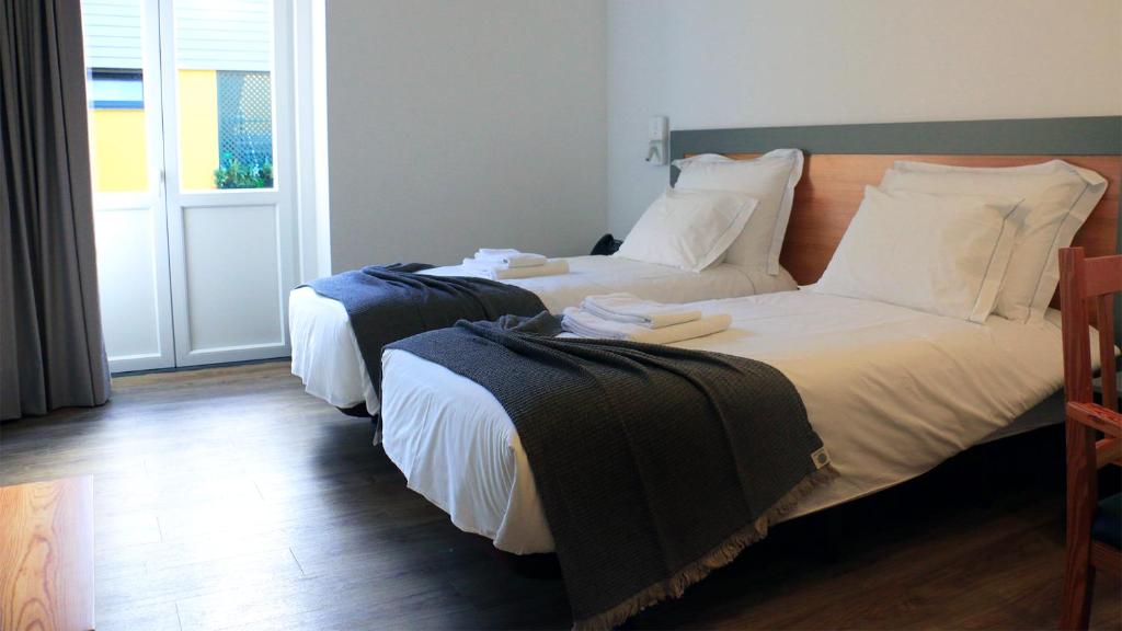 Postel nebo postele na pokoji v ubytování Aliança café & hostel