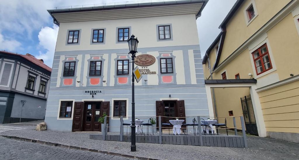 a building with a street light in front of it at Hotel Salamander in Banská Štiavnica