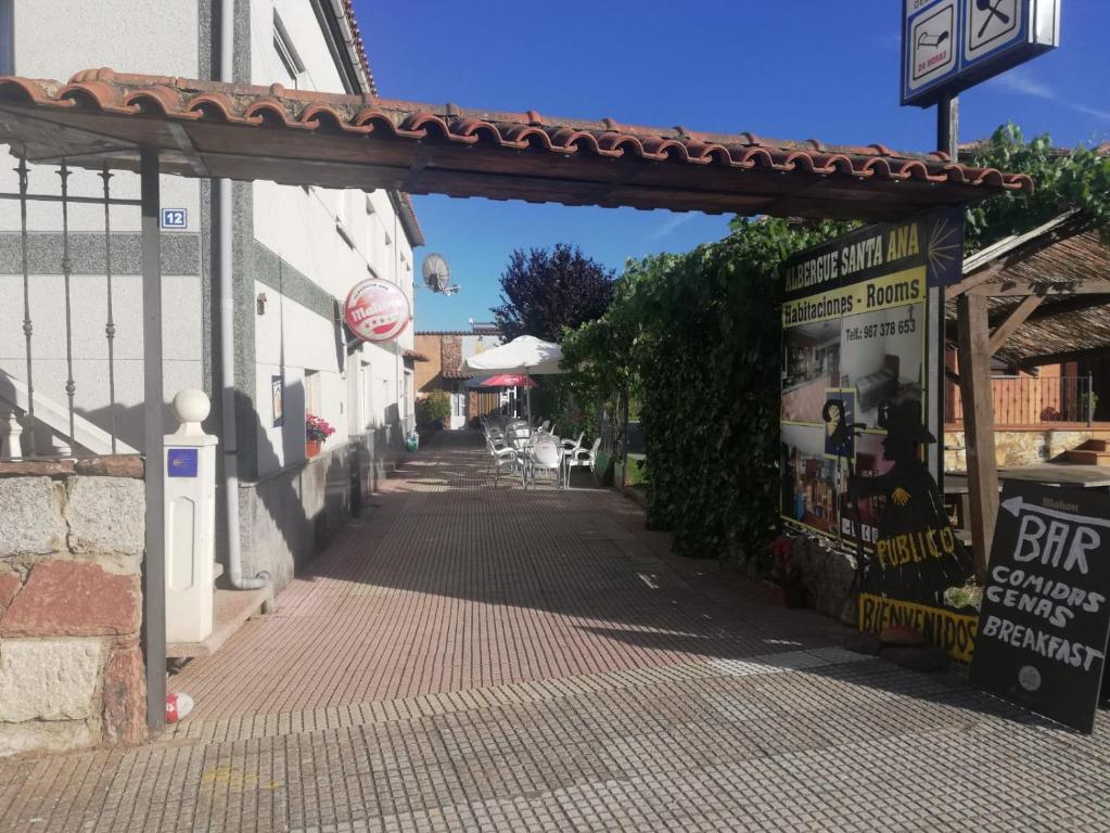 een lege straat met een boog over een stoep bij Albergue Santa Ana in San Martín del Camino