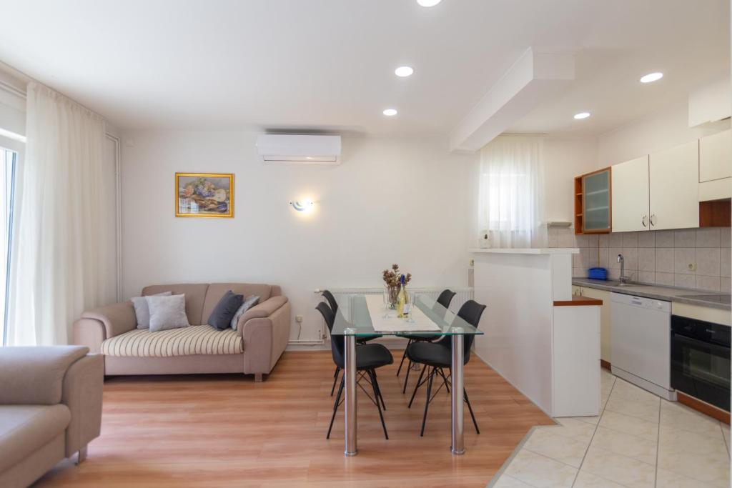 a kitchen and living room with a table and chairs at Two lakes in Imotski