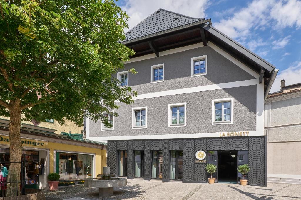 a gray building with a black roof at La Sonett in Gmunden