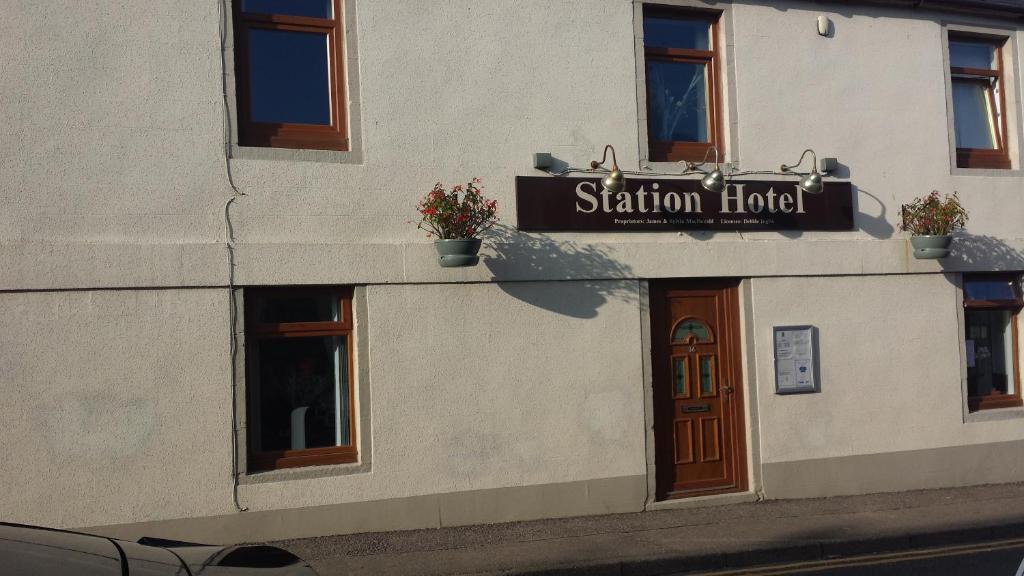 a building with a sign on the side of it at Station Hotel in Hopeman