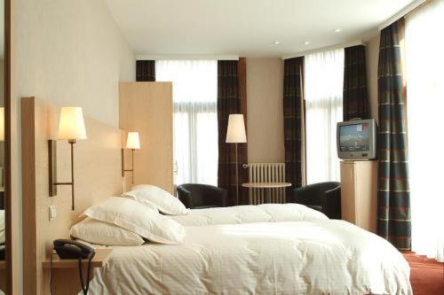 Postel nebo postele na pokoji v ubytování Hotel Escapade