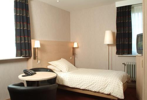 Postel nebo postele na pokoji v ubytování Hotel Escapade