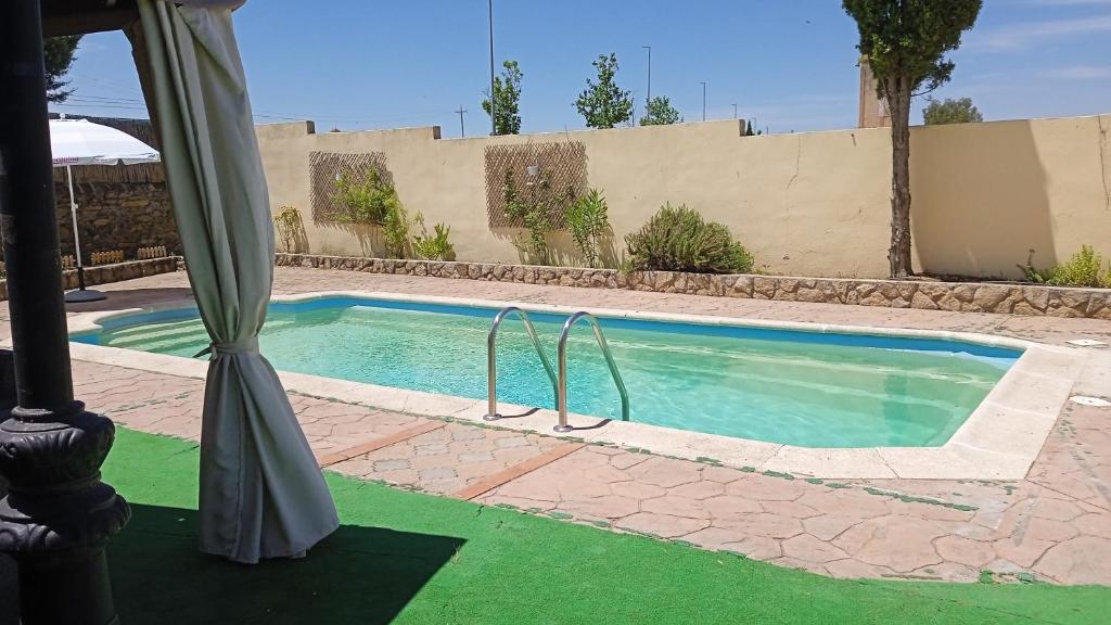 una piscina con suelo verde en una casa en Orion, en Torrejón el Rubio