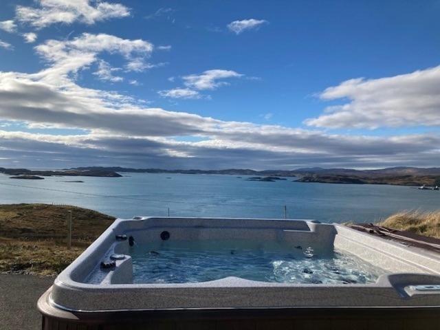 a bath tub with a view of a body of water at Braemore Cottage in Tarbert