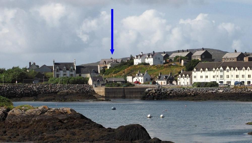 a blue arrow points to a town in the water at Tulloch House in Lochboisdale