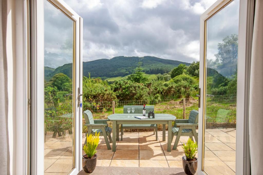 a view of a patio with a table and chairs at Branter Lodge in Strachur