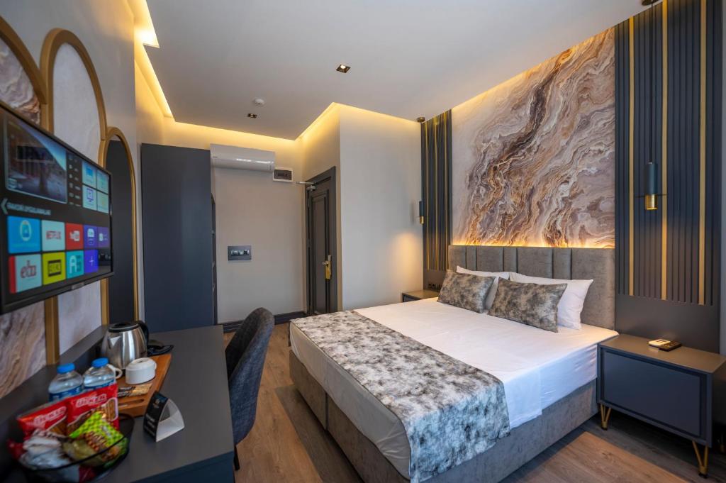 ArnavutköyにあるWorld Class Airport Hotelのベッドとデスクが備わるホテルルームです。