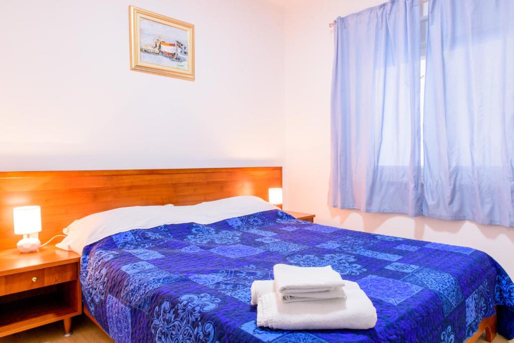 Postel nebo postele na pokoji v ubytování Apartman Lu