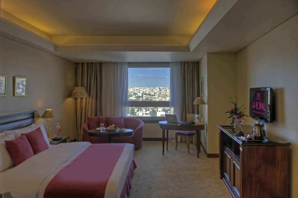 a hotel room with a bed and a window at Le Royal Amman in Amman