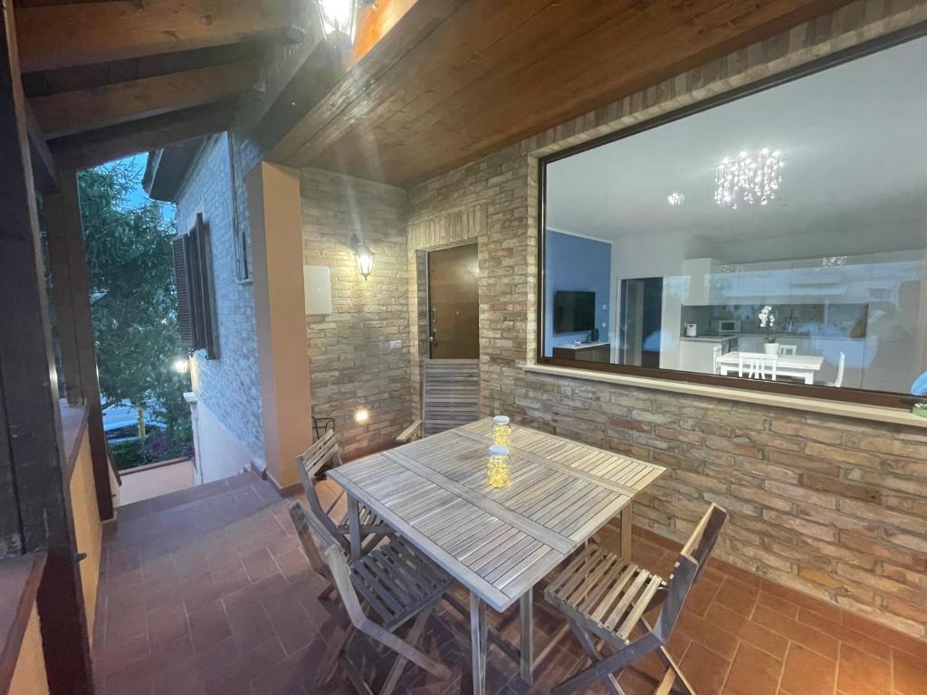 a wooden table and chairs on a patio at Casa Drema - Villa al mare con terrazza in Pescara