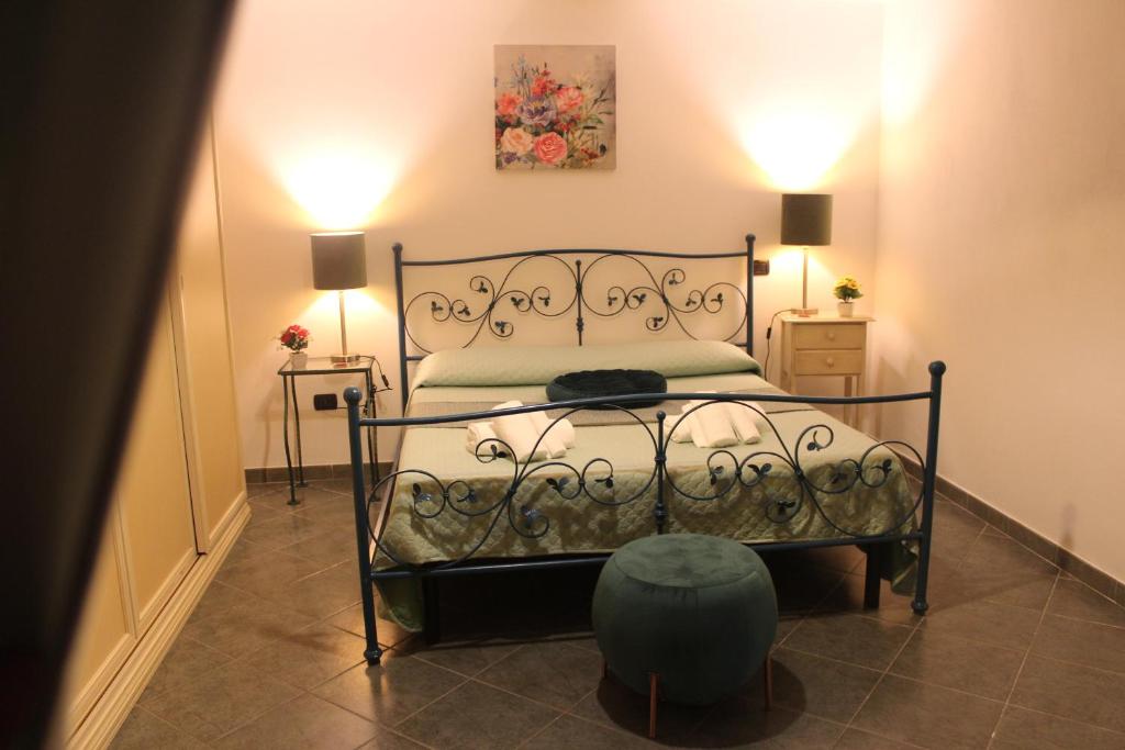 a bedroom with a bed with a metal frame at Al Fortino Normanno in Castelmezzano