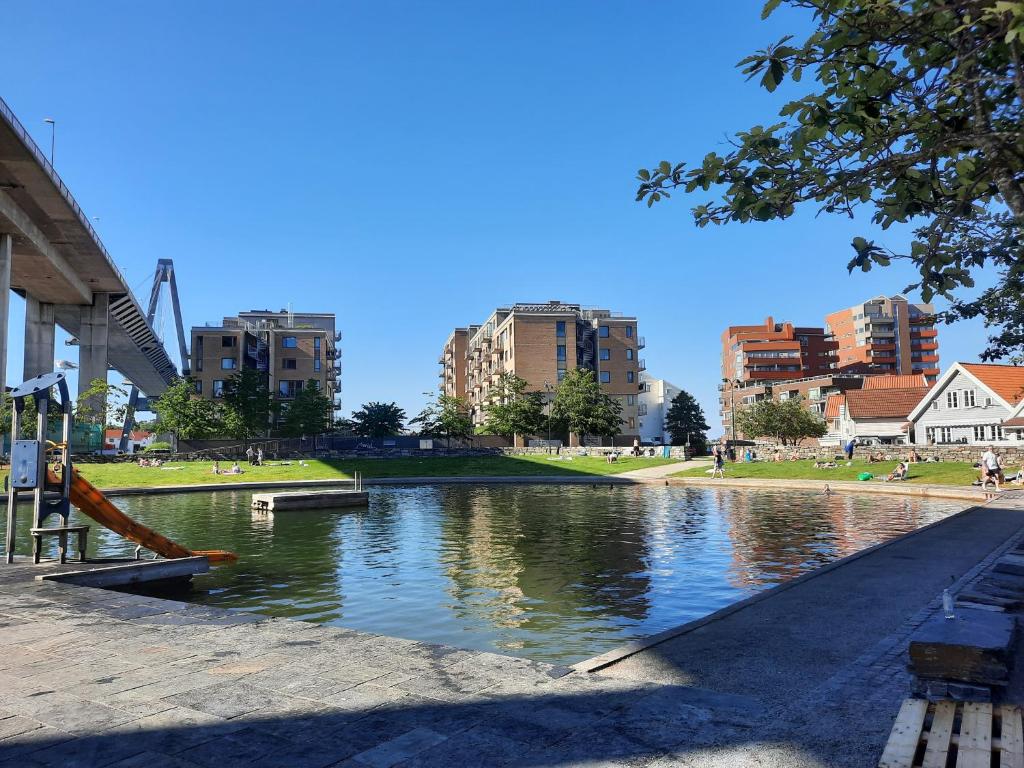 a river in a city with buildings in the background at Gabriel's Home in Stavanger