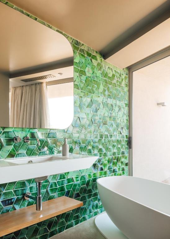 a bathroom with a sink and a mirror at Immerso Hotel, a Member of Design Hotels in Ericeira