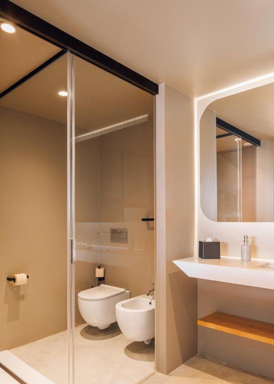a bathroom with a toilet and a sink at Immerso Hotel, a Member of Design Hotels in Ericeira