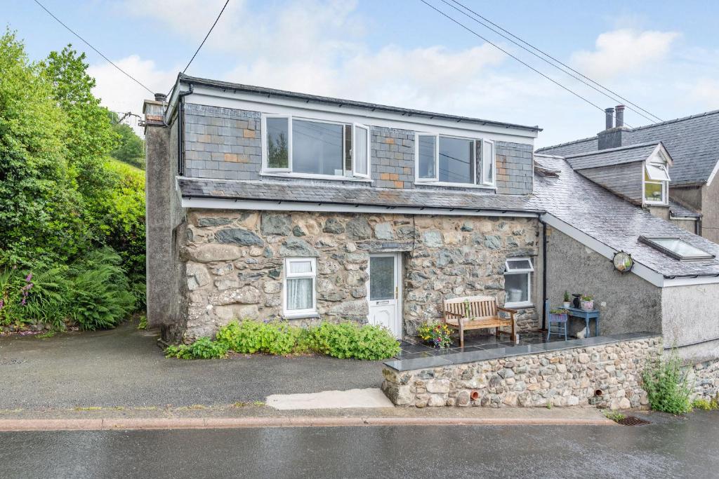 an image of a stone house with a patio at Penty in Dolgellau