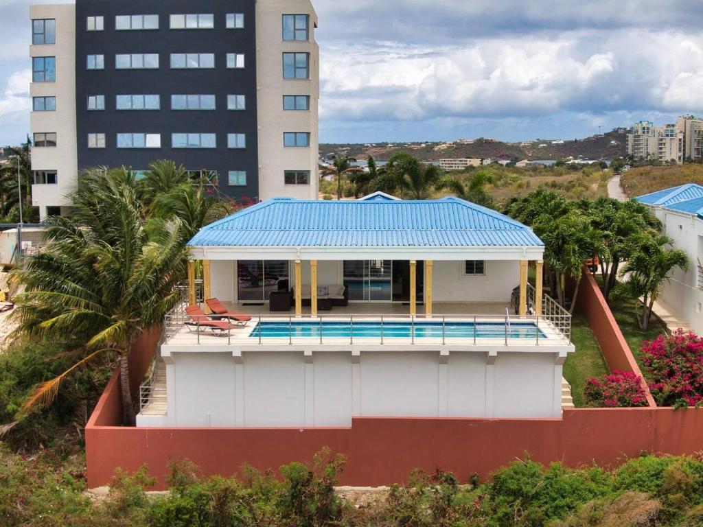 a house with a blue roof on top of it at Airport View 3-Bed Villa in Cupecoy