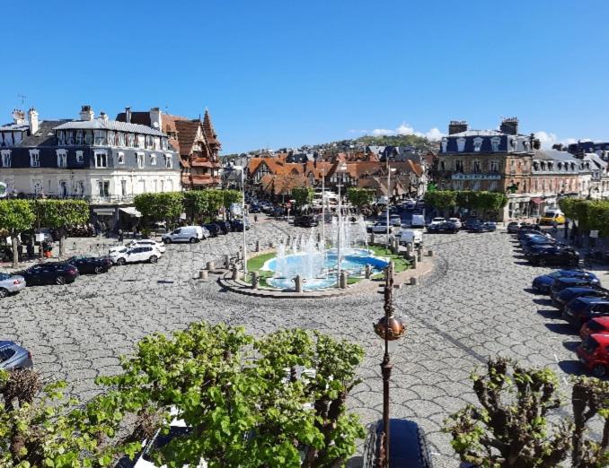 a city with a fountain in a parking lot at Morny Belvédère in Deauville