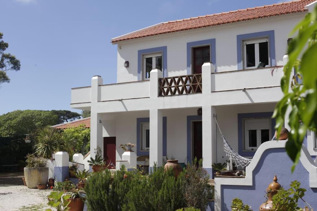 a large white house with a balcony at Sintra Farm Villa Guest House in Sintra